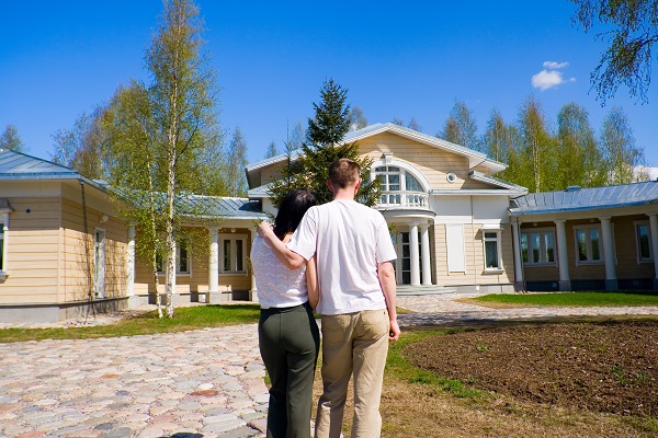 couple in front of house